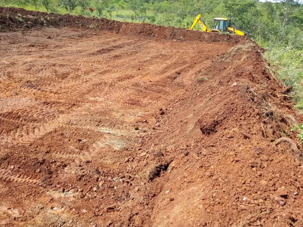 Freshly cut red earth platform with BMR machine on the ridge