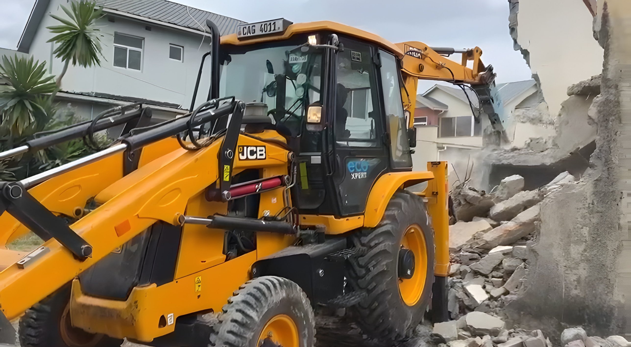 BMR backhoe loader demolishing a building